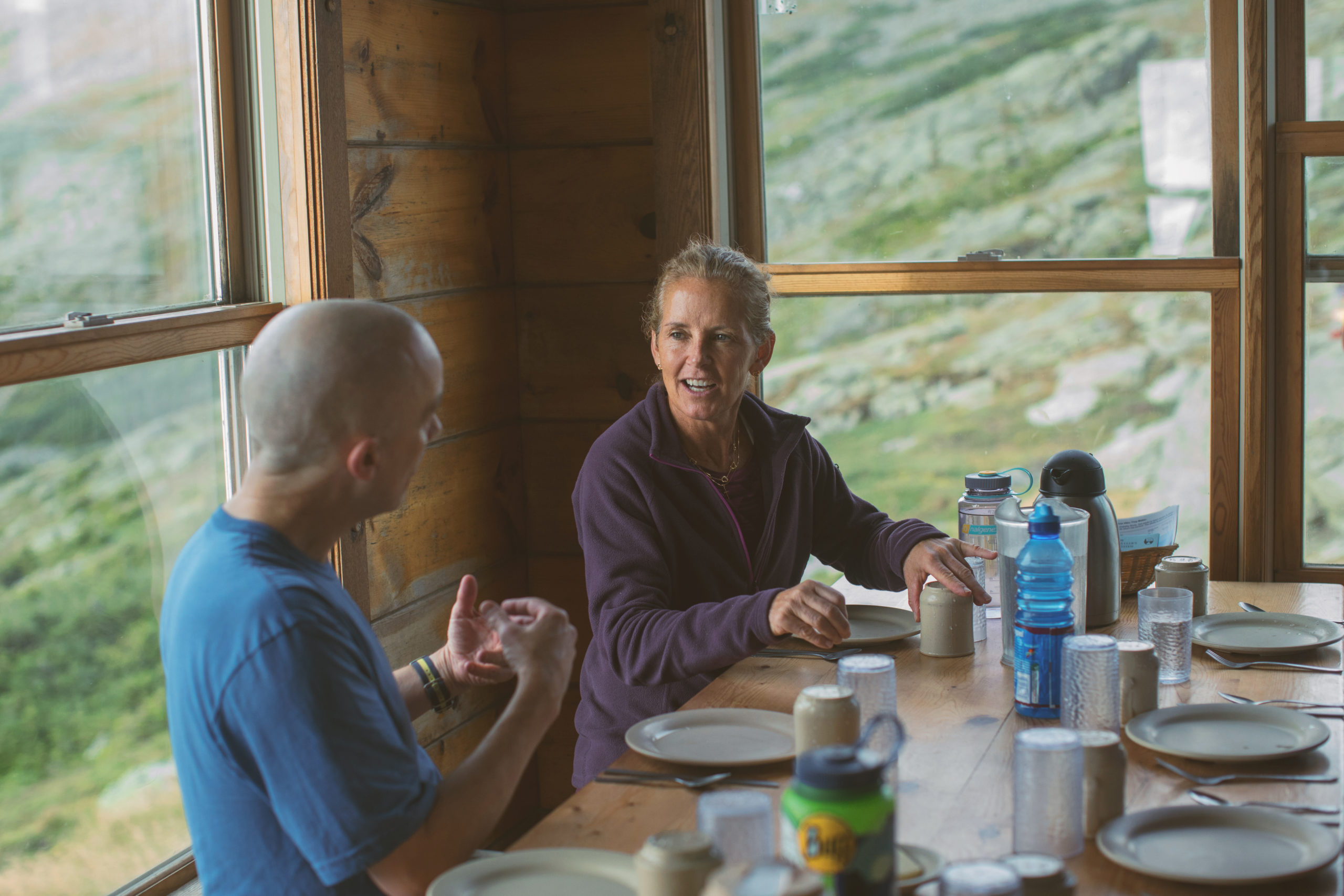 Guests at dining table at Lakes of the Clouds Hut