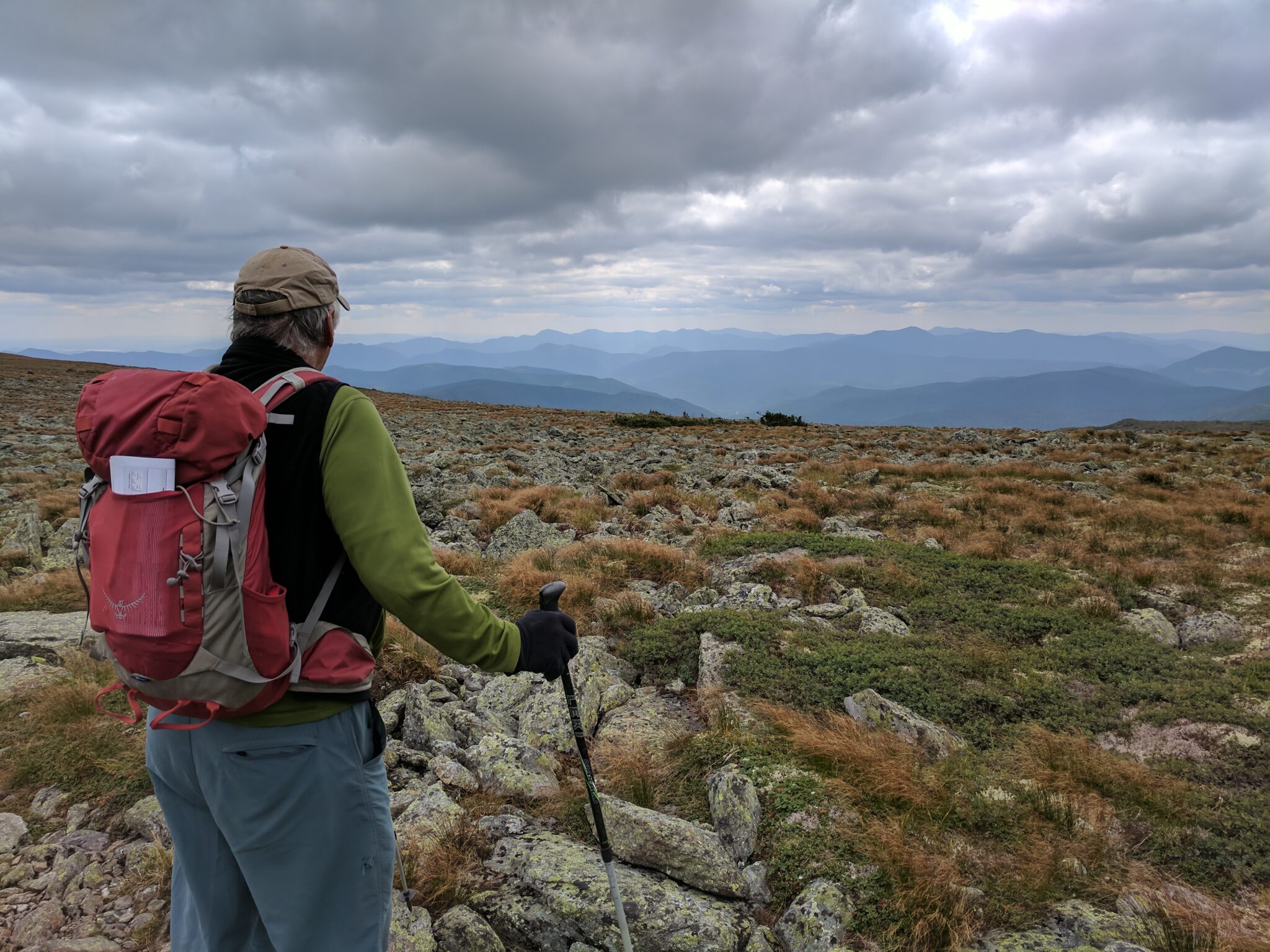Courtesy of George BrownBrown taking in the views while on a hike in the White Mountain National Forest. A new trail sign for the Davis Path sits in his pack.