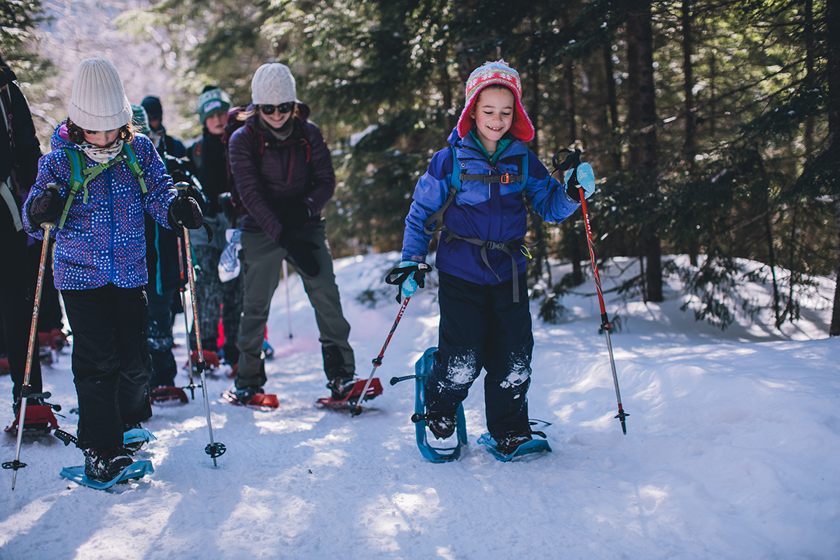 A family snowshoeing in the woods